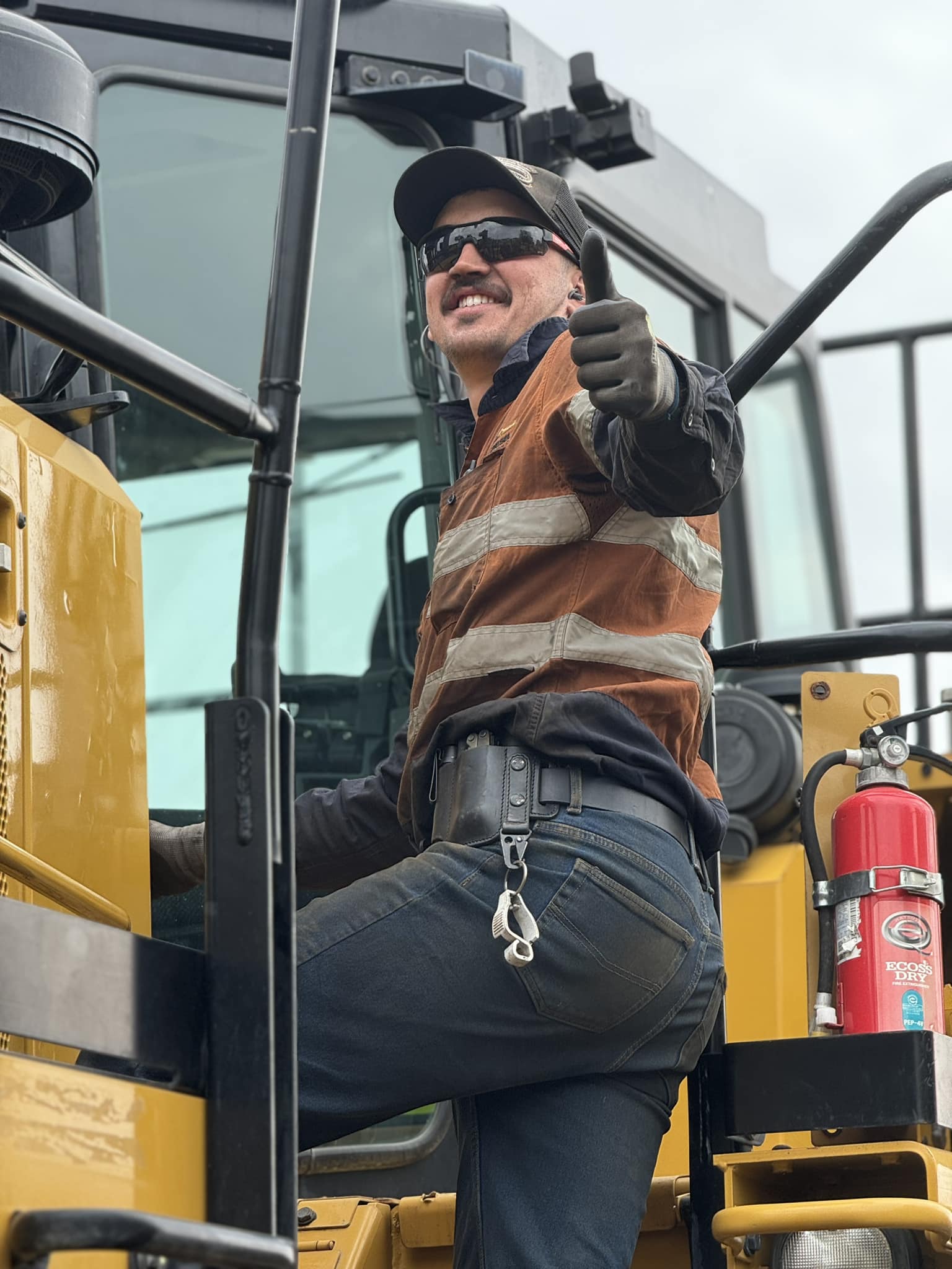Worker standing on heavy machinery